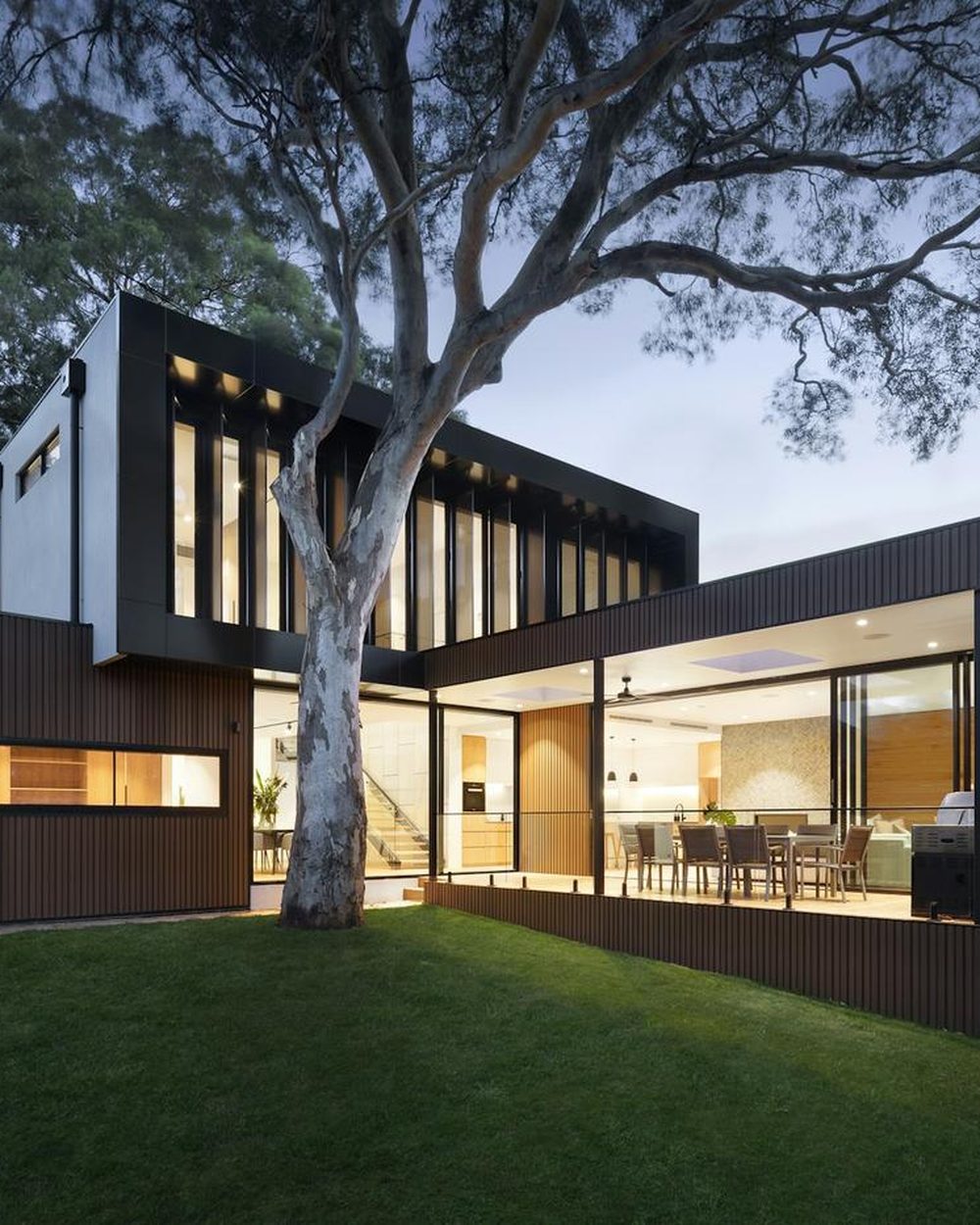 A modern home at dusk that UHN Capital can help you sell